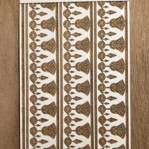 Intricate brown and white patterned fabric strip on wood.