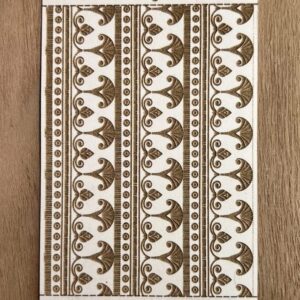 Decorative fabric with symmetrical brown floral patterns on a beige background.