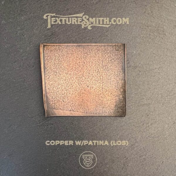 Close-up of a copper square with patina gloss texture on a gray background.