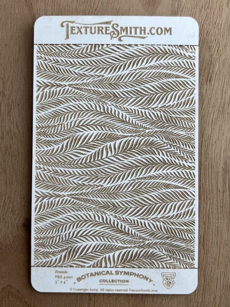 Decorative fabric with a wavy leaf pattern in neutral tones.