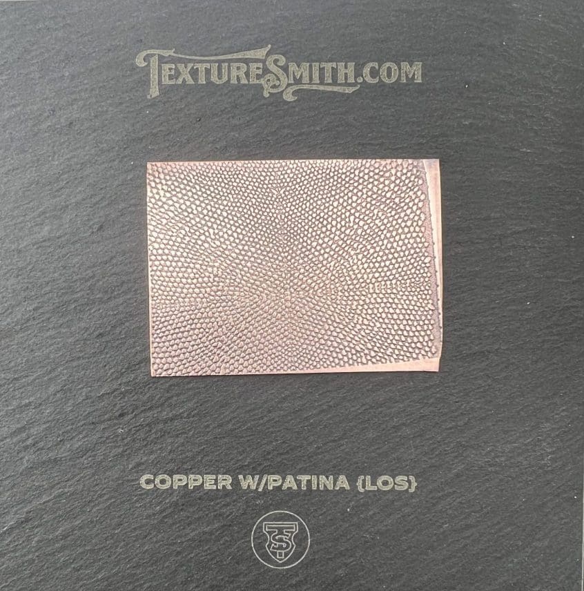 Copper sheet with a patina texture on a black background.