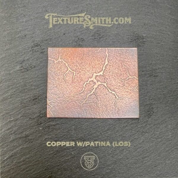 Close-up of a cracked copper surface with a glossy finish.