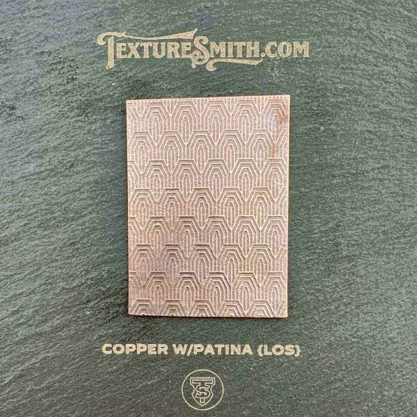 Copper patina textured metal sheet with a grid pattern.