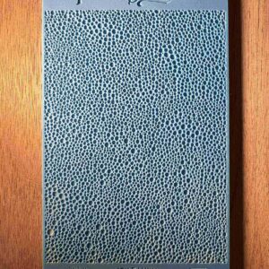Blue textured notebook on a wooden surface.
