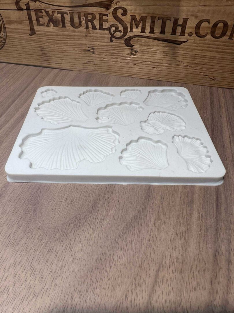 A white puzzle piece board with animal shapes on a wooden table.