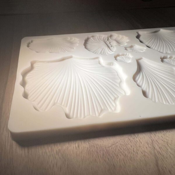 Elegant white 3D floral relief on a rectangular surface.