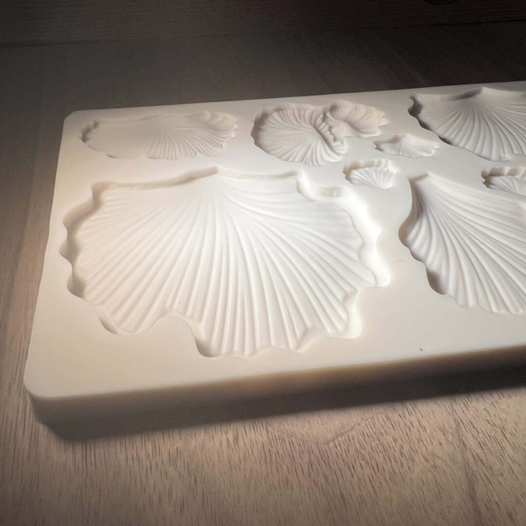 Elegant white 3D floral relief on a rectangular surface.