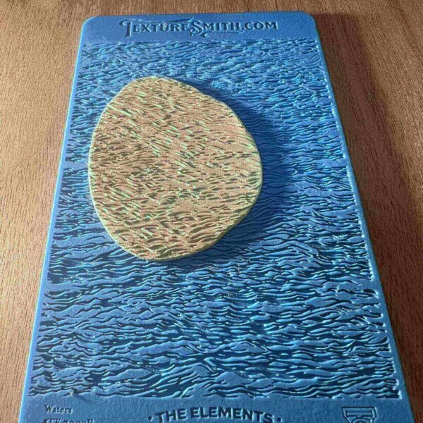 Book cover featuring a large, textured rock on a blue, wavy background.