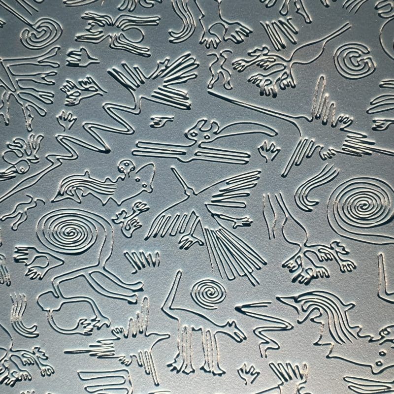 Intricate petroglyphs etched into stone surface.