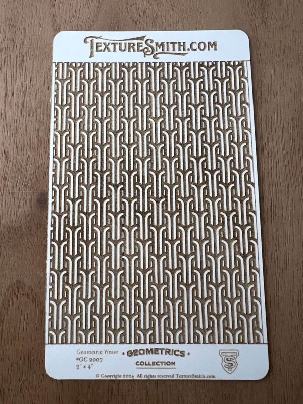 A patterned textile or wallpaper with interlocking geometric design in neutral colors.