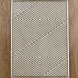 Geometric patterned rug with diagonal lines and maze-like design.