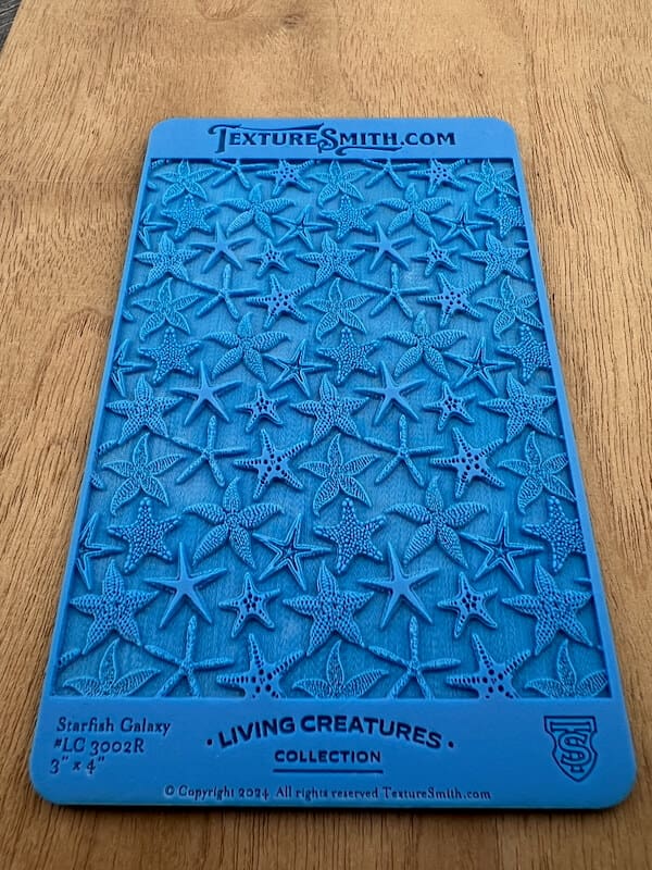 Blue silicone mold with starfish shapes for crafting or baking.