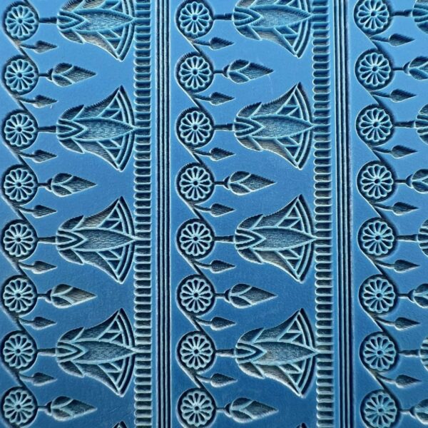 Blue fabric with intricate geometric and floral patterns in repeating vertical strips.