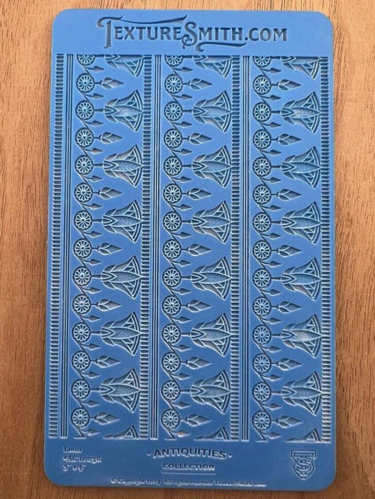 Blue decorative book cover with intricate embossed patterns.