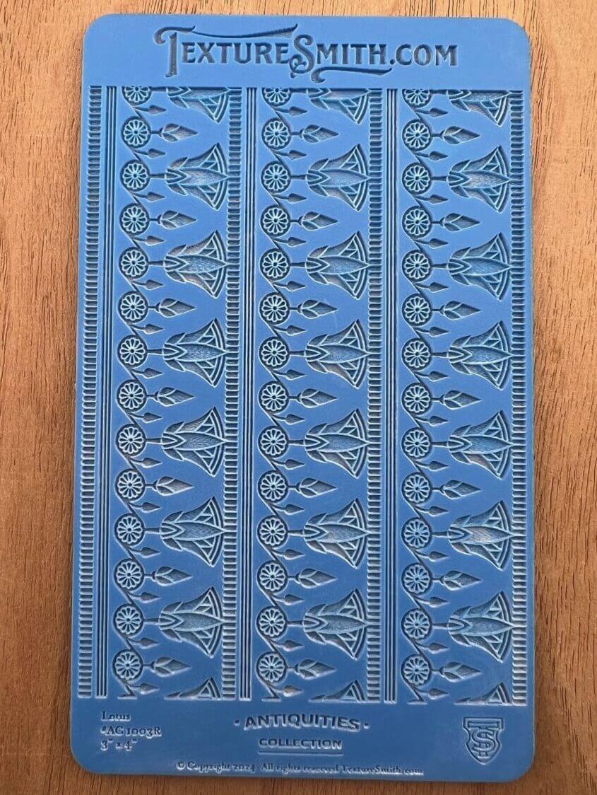 Blue decorative book cover with intricate embossed patterns.