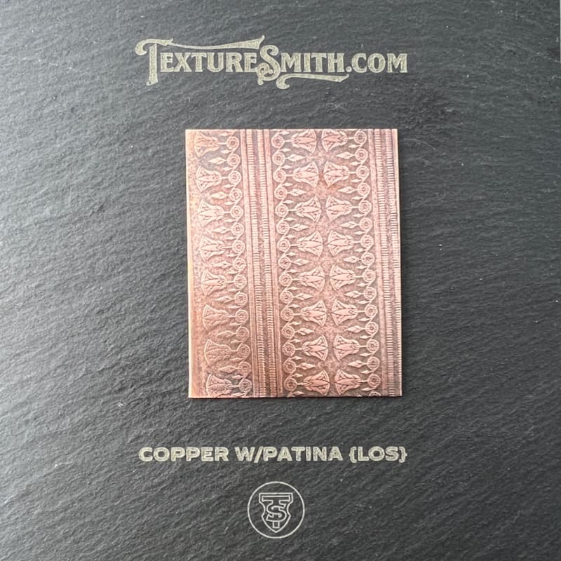 Copper wapatia metal sheet with intricate embossed patterns.