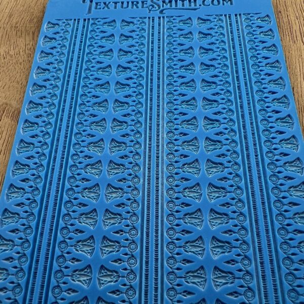 Blue textured mat with repetitive patterns and text at the top.