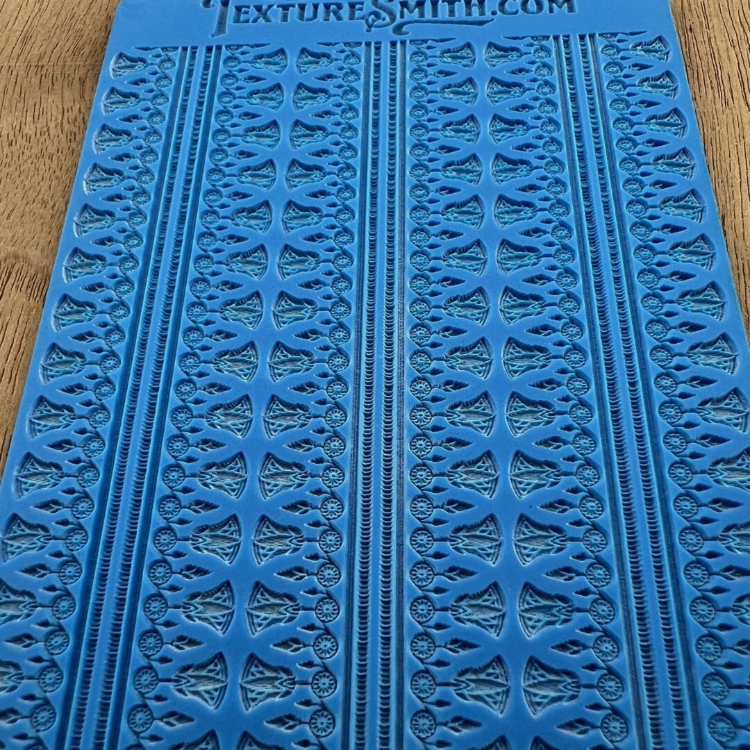 Blue textured mat with repetitive patterns and text at the top.