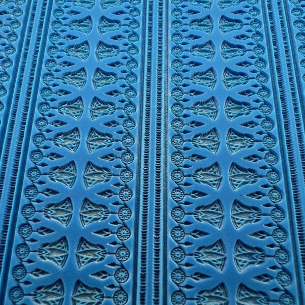 Intricate blue patterned textile with symmetrical designs.