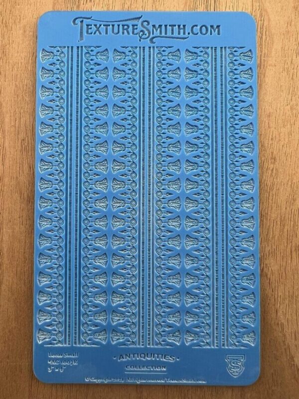 Close-up of a blue textured book cover with intricate patterns.