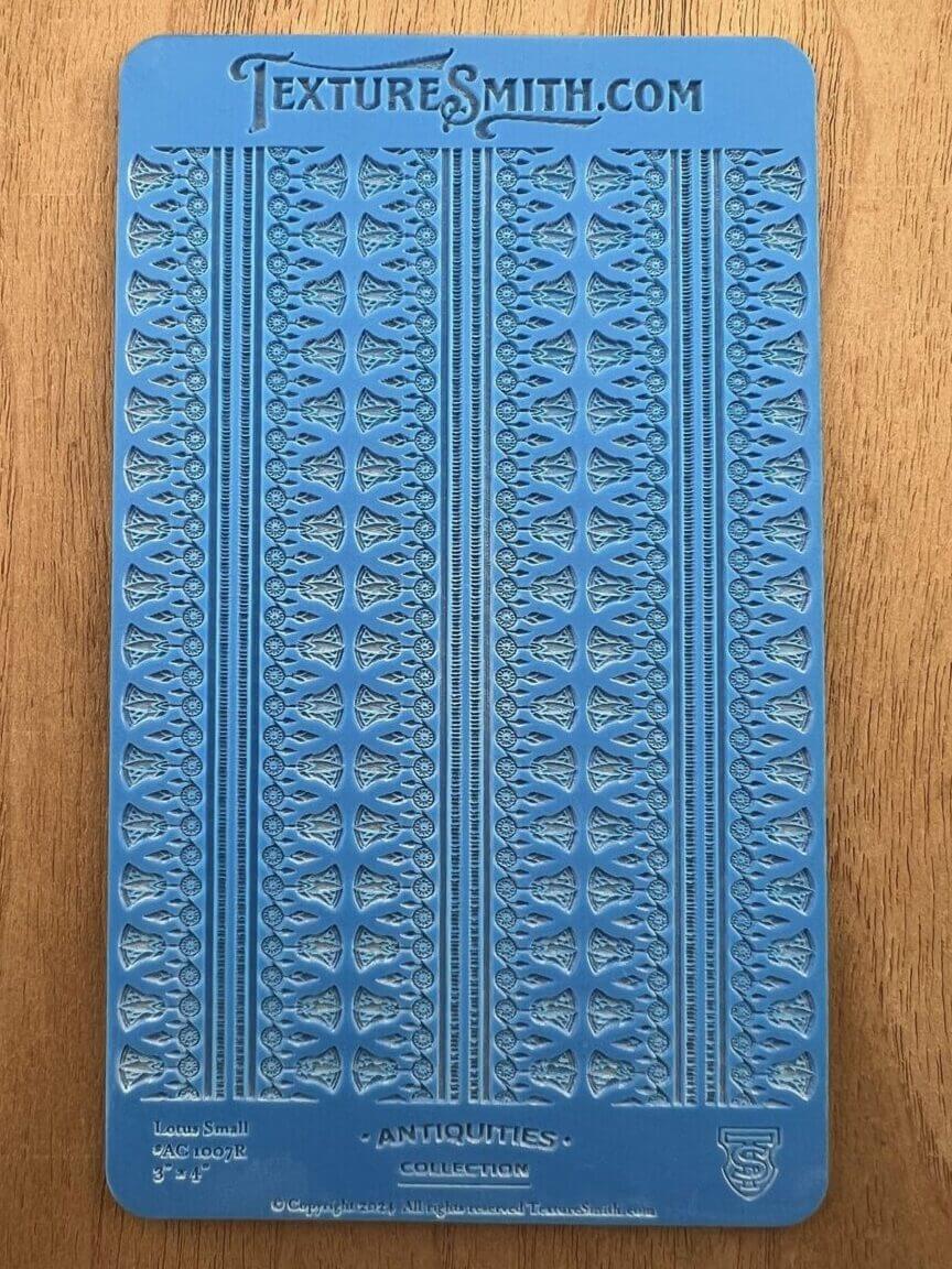 Close-up of a blue textured book cover with intricate patterns.