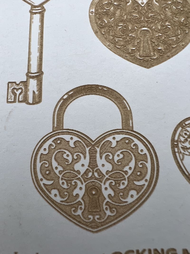 Ornate heart-shaped lock and vintage key with intricate designs.