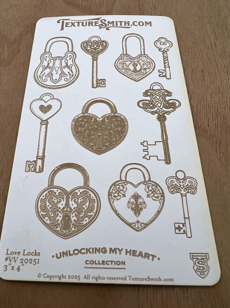 Intricate vintage keys and heart-shaped locks on a sheet.