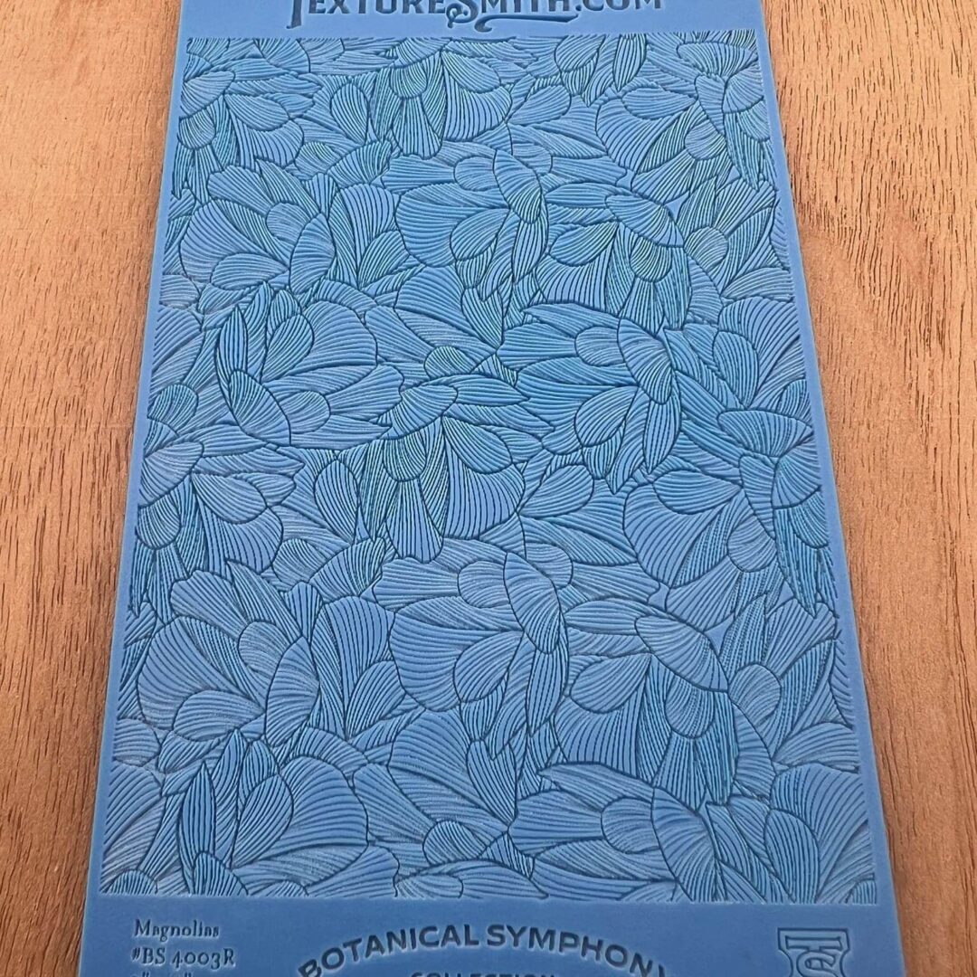 Blue book cover with leaf pattern and title.