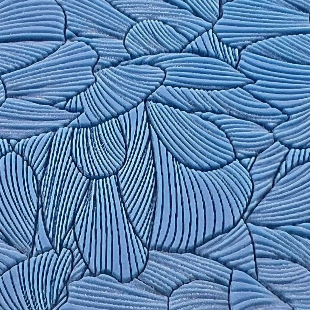 Blue abstract pattern resembling overlapping petals or leaves.