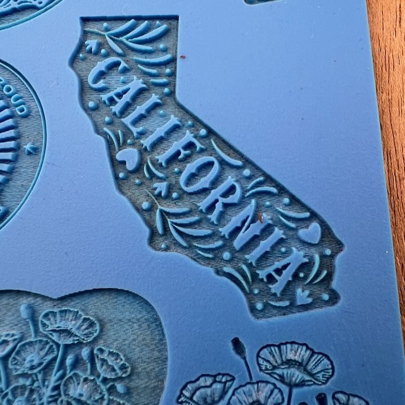 A silicone mold shaped like California with the word 'California' embossed.