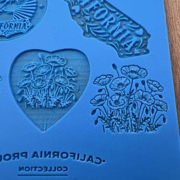 Blue paper with California-themed cutouts and drawings.