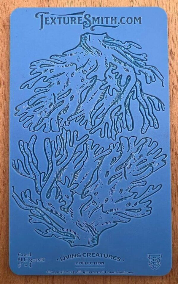 Blue abstract artwork with organic, branching shapes on a wooden background.
