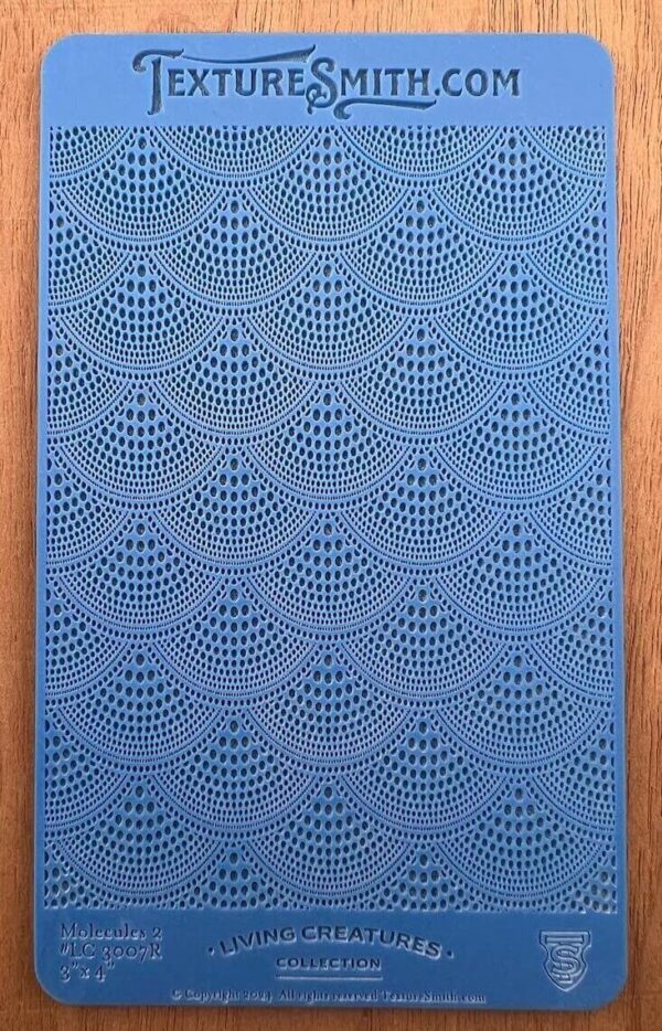 Blue crochet fabric with intricate scalloped patterns.