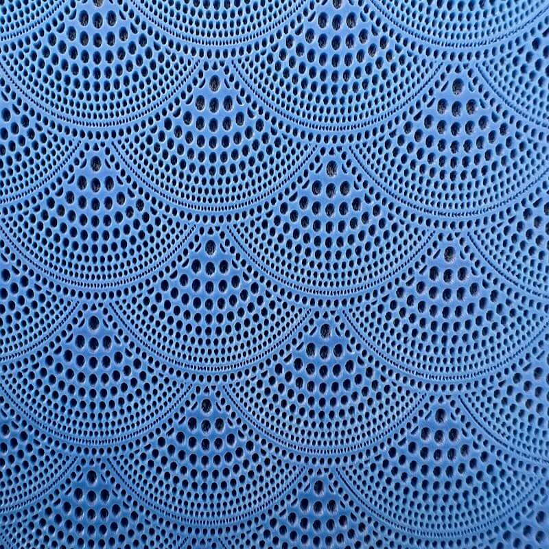 Blue crochet pattern with repeating semi-circles and intricate details.