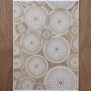 Textured wall panel with circular, geometric patterns in neutral tones.