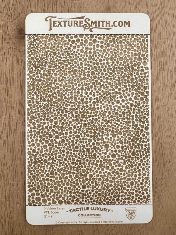 Brown and white leopard print fabric laid on a wooden surface.