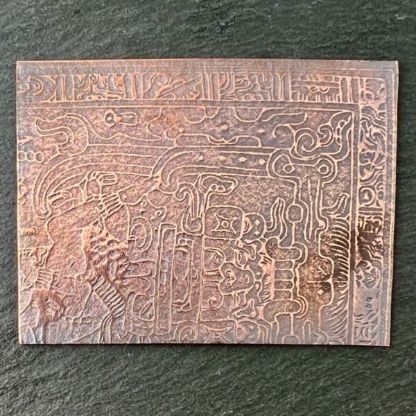 Intricately carved ancient script on a rectangular stone tablet.