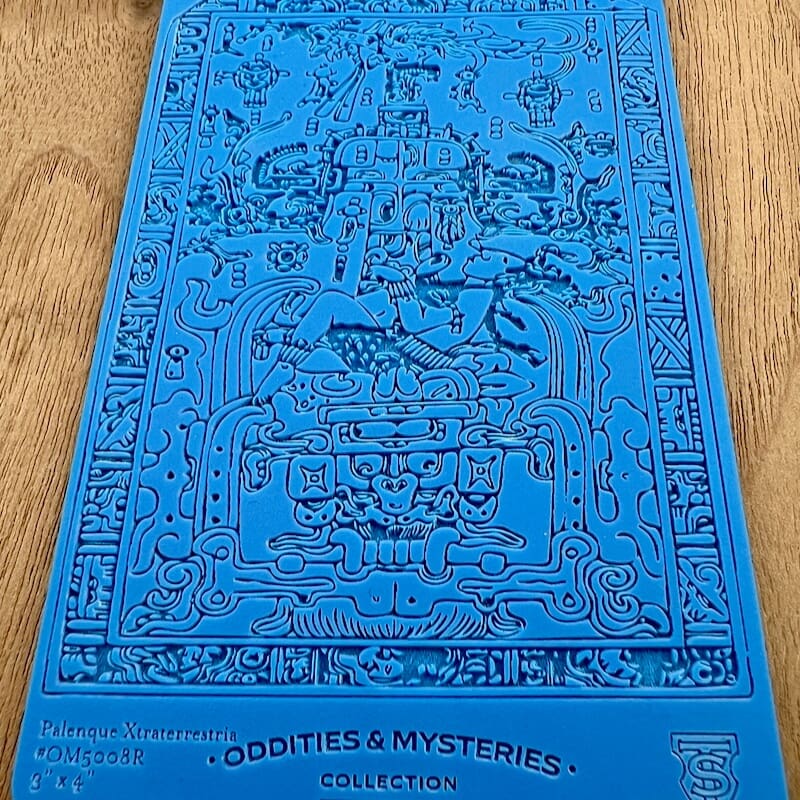 Blue yoga mat with detailed black illustrations and text.