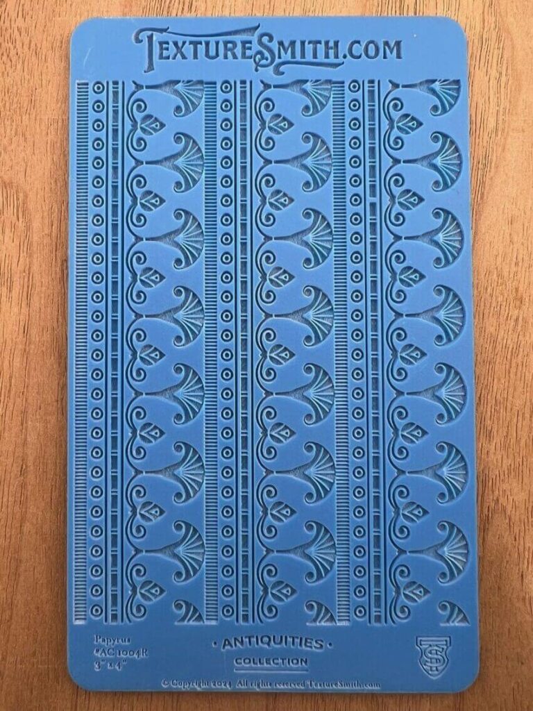 Blue book cover with intricate embossed floral patterns.