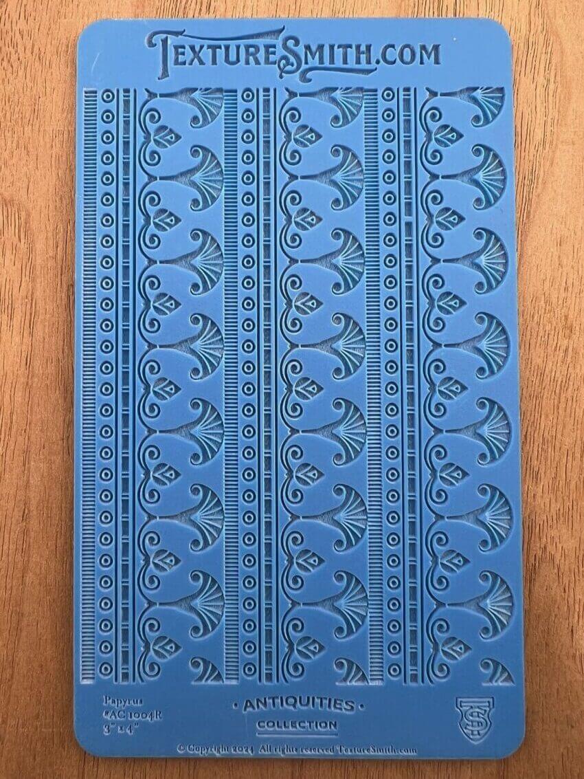 Blue book cover with intricate embossed floral patterns.