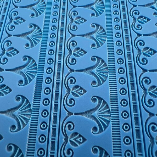 Blue fabric with intricate black floral and geometric patterns.