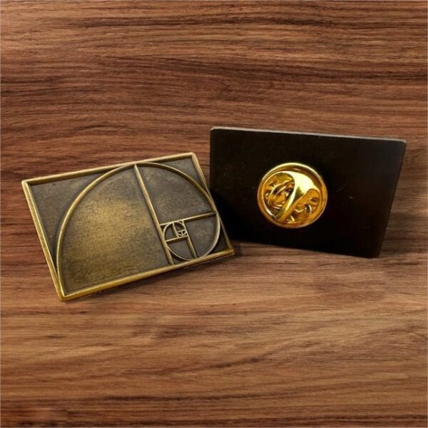 Two decorative desk plaques featuring the golden ratio and a mechanical watch movement.
