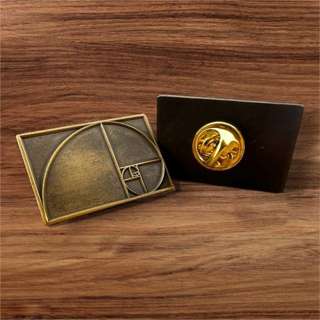 Two decorative desk plaques featuring the golden ratio and a mechanical watch movement.
