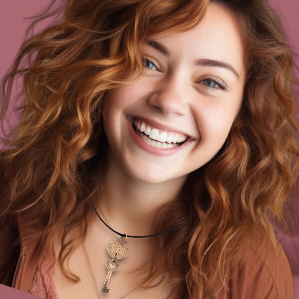 Smiling woman with curly red hair and layered necklaces.