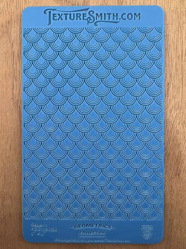 Close-up of a blue textured surface with a diamond pattern on wood.