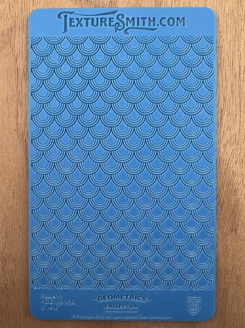 Close-up of a blue textured surface with a diamond pattern on wood.