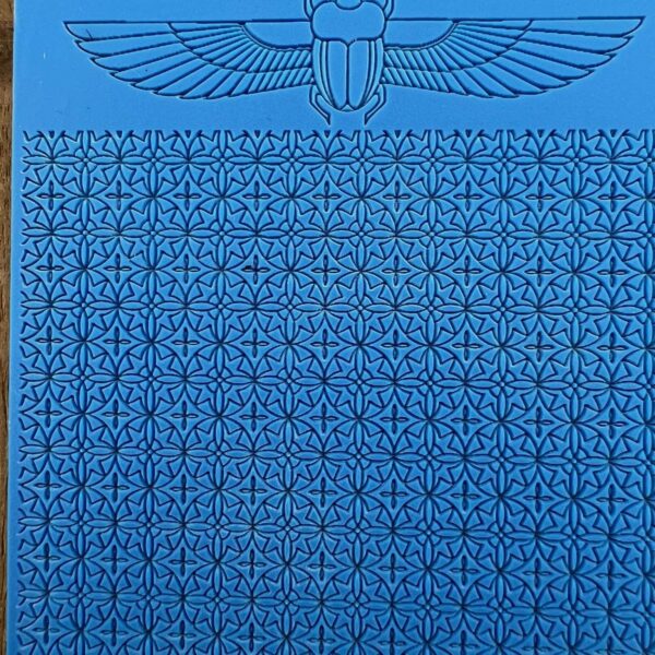 Ancient Egyptian-style wall with hieroglyphics and winged sun disk symbol.