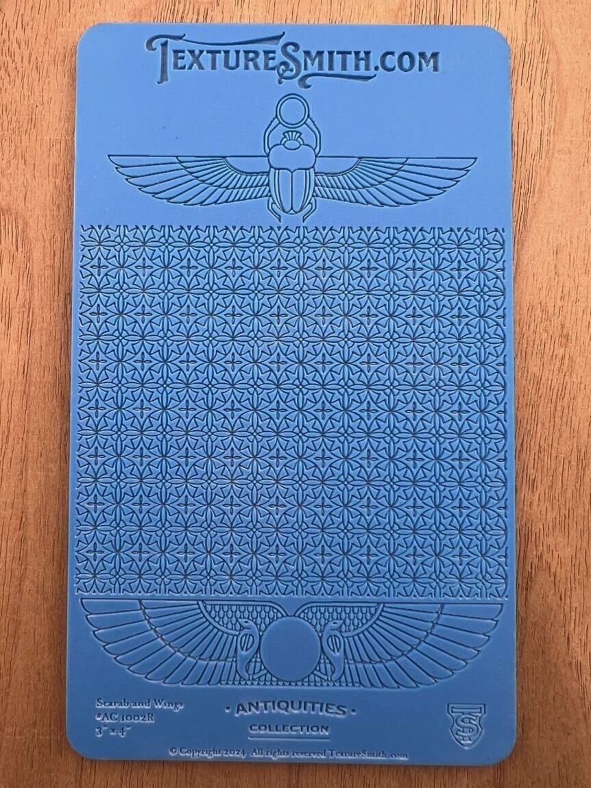 Blue panel with intricate Egyptian hieroglyphs and symbols.