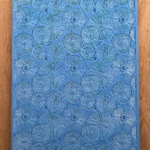 Blue textured surface with circular patterns and a wooden frame.