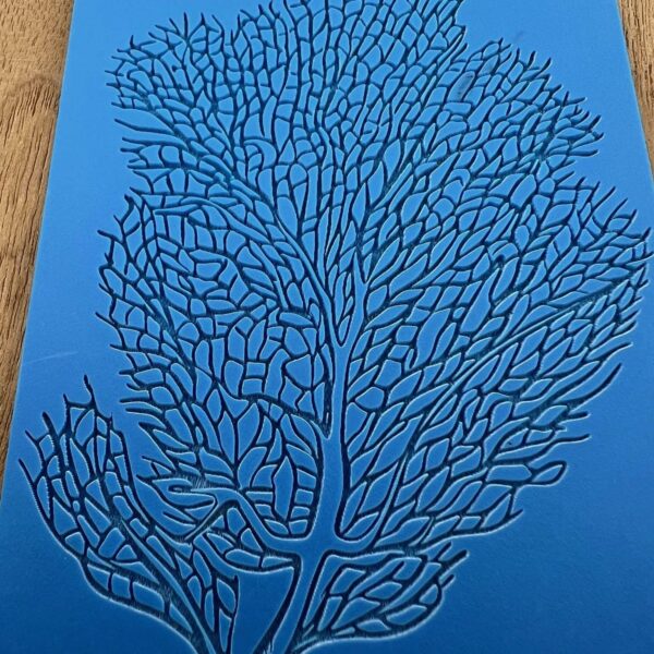 Intricate blue coral-like pattern on a blue background.